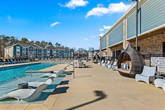 Pool side seating area at Ardmore Meadows Apartments, North Carolina, 27377