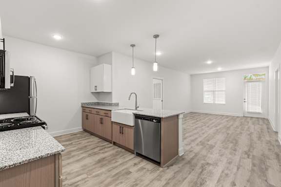 A modern kitchen with a black stove top oven and a dishwasher.