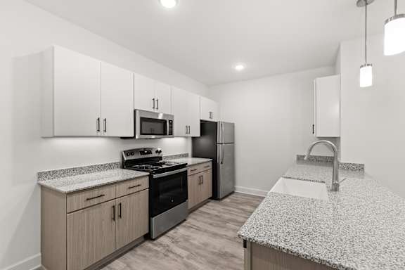 A kitchen with granite countertops and stainless steel appliances.