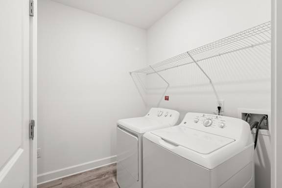 A white washing machine and dryer in a small laundry room.