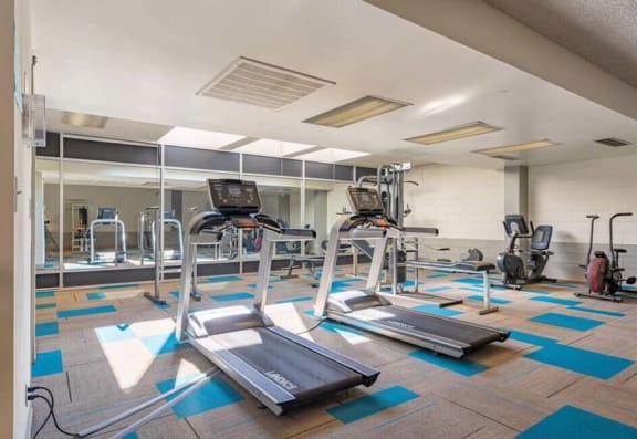 a gym with treadmills and other exercise equipment at Mountainview Venture, Covina California