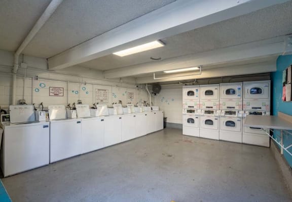 a room filled with lots of white washers and dryers at Mountainview Venture, California