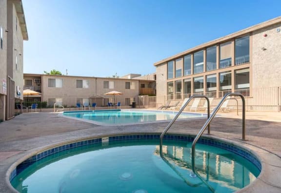 a resort style pool and hot tub with a building in the background at Mountainview Venture, Covina