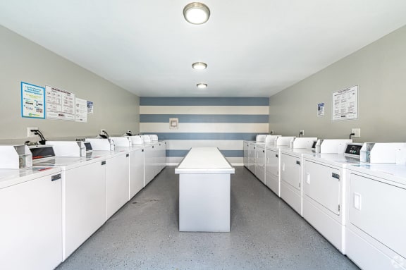 the laundry room is equipped with washers and dryers  at Colima Terrace Apts, Rowland Heights, CA 91748