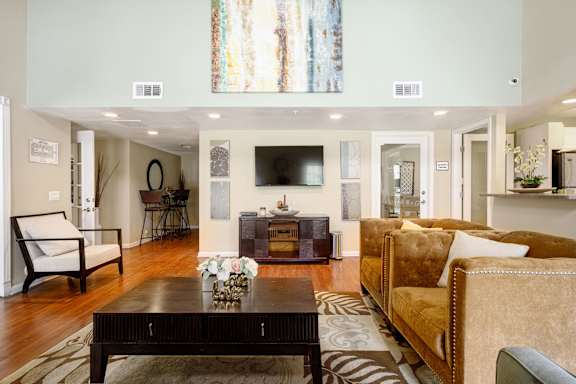 a living room filled with furniture and a flat screen tv at Sagewood Gardens Senior Apartments, Hacienda Heights