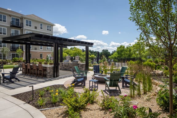 an outdoor patio with tables and chairs and a building in the background