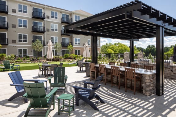 a patio with tables and chairs and a pergola