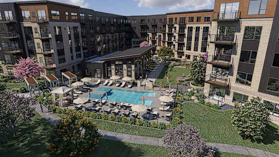 A large outdoor pool surrounded by lounge chairs and umbrellas.