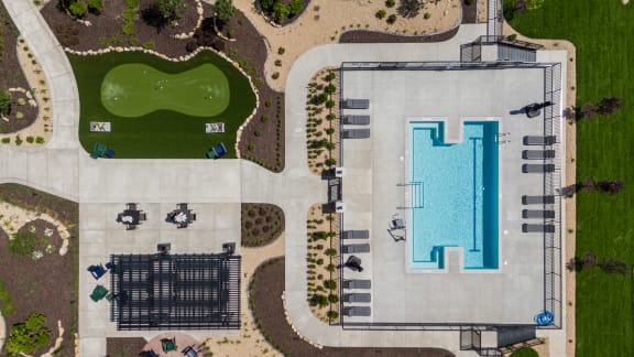 arial view of a swimming pool and a grassy area with umbrellas