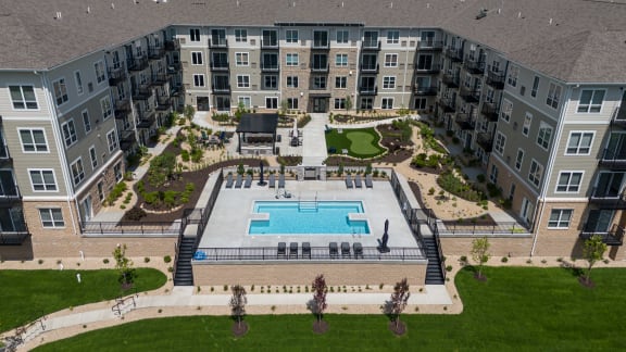 an aerial view of an apartment building with a swimming pool