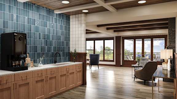 A modern kitchen with wooden cabinets and a blue tile backsplash.