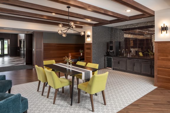a dining room with a table and chairs and a kitchen