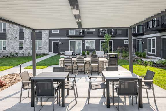 A patio with a table and chairs is set up outside a building.
