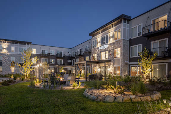 Apartment complex named Murphy with a garden in front.