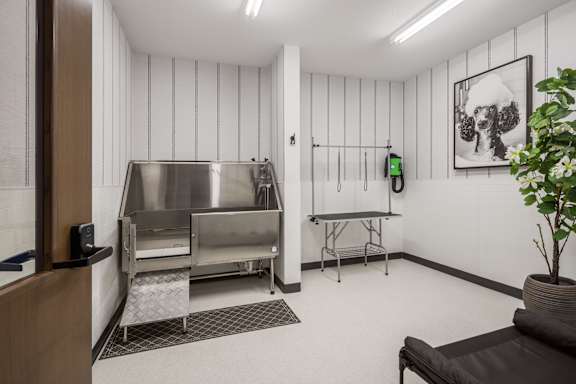A room with a stainless steel oven and a table.