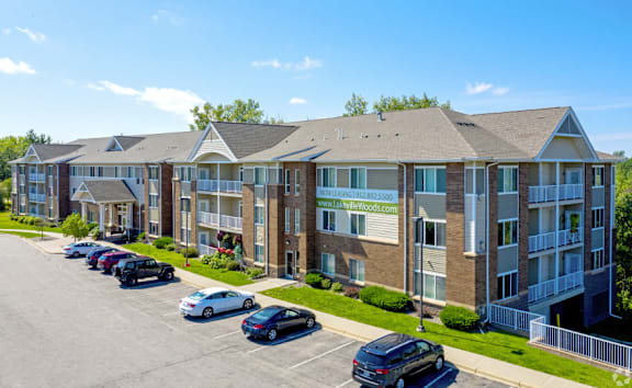Apartment complex with cars parked in front.