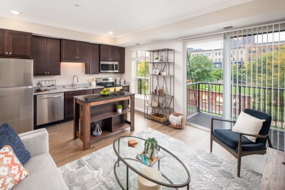 a spacious living room with a kitchen in the backgroundat The Carver Apartments, Minnesota