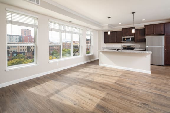 a kitchen and living room with a large windowat The Carver Apartments, Chaska, MN