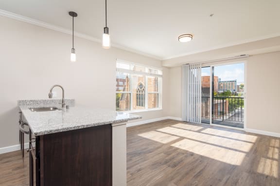 a kitchen and living room in a 555 waverly unitat The Carver Apartments, Chaska, MN