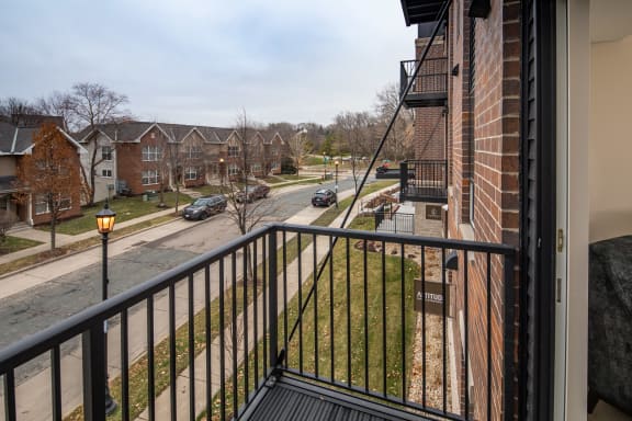 a balcony with a black railing and a street in the backgroundat The Carver Apartments, Chaska, MN 55318