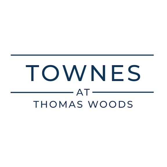 A logo with the words "Towne at Thomas Woods" in blue.