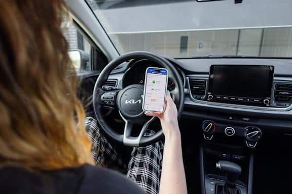 A woman is using her phone while driving a car.