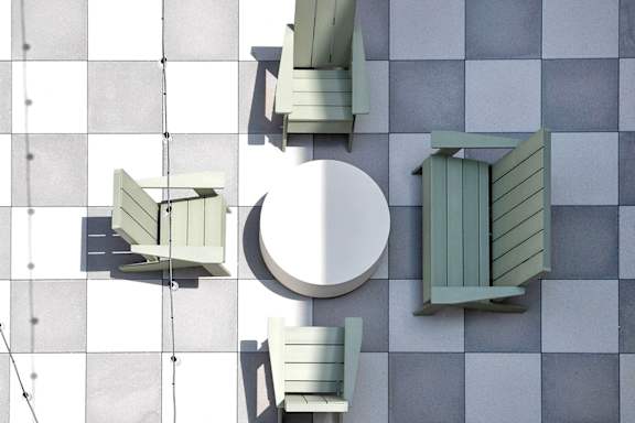 Outdoor lounge at The Artisan at 39th in Omaha, NE green chairs.
