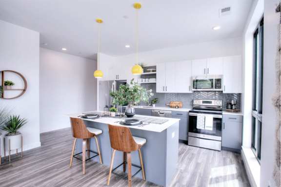 A modern kitchen with a dining table and chairs.