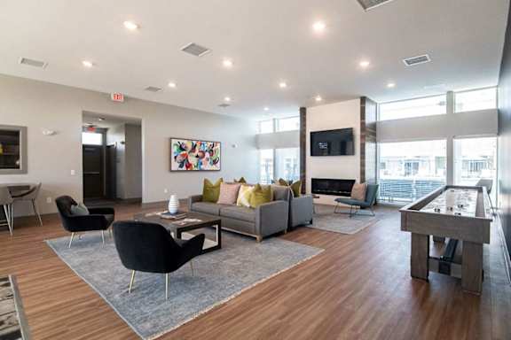 A modern living room with a pool table and a television.