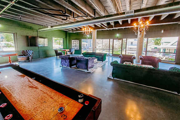 A billiard table is in the foreground of this image.