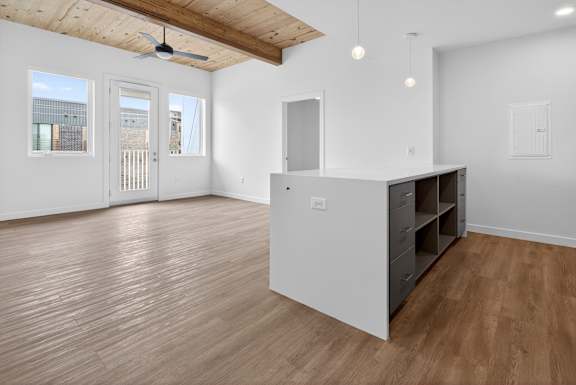 A room with wooden floors and a ceiling fan.