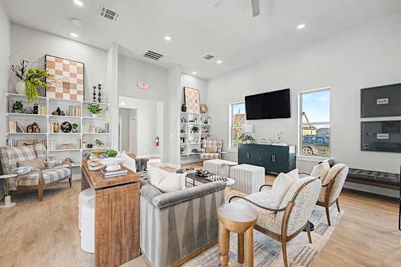 A living room with a couch, chair, and a television.