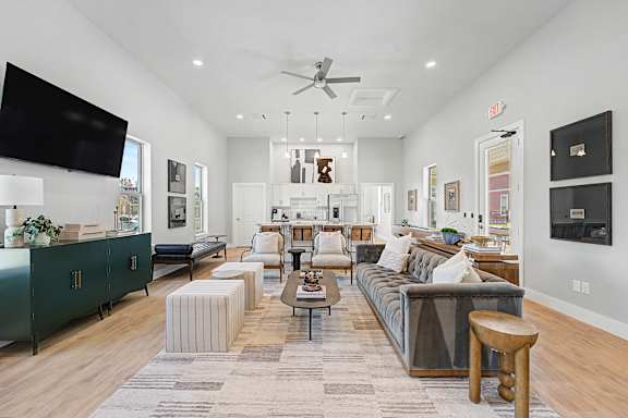 A living room with a grey couch and a green cabinet.