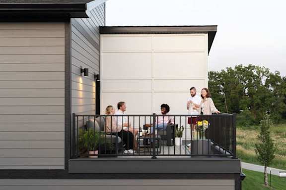 A group of people are sitting on a balcony.