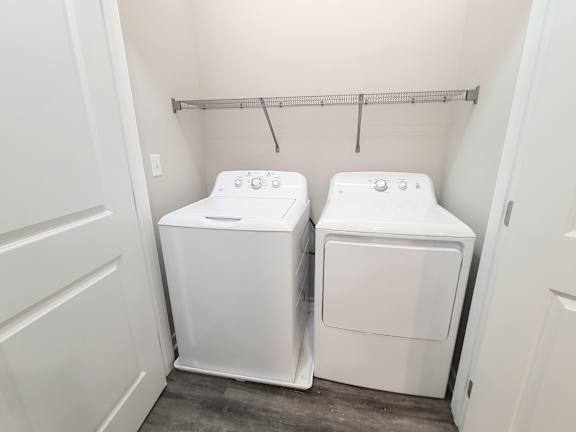 A small laundry room with a washer and dryer.