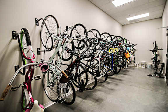 A bike shop with many bikes hanging on the wall.