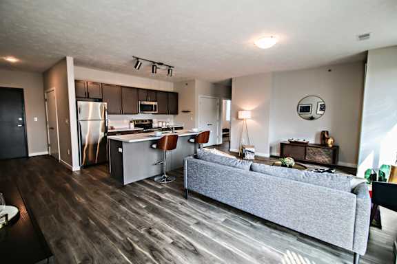 A modern kitchen with a refrigerator, stove, and sink.