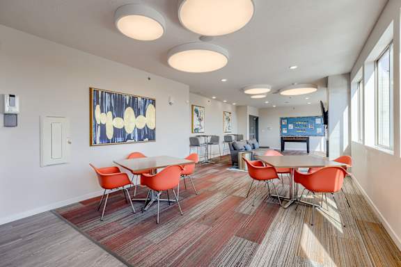 A room with a long table and chairs.