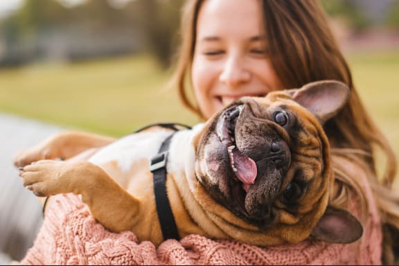 a woman holding a dog