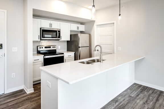 One, two and three-bedroom floor plans featuring two interior design schemes, quartz countertops, tile backsplash, stainless steel appliances, backlit mirrors, high-end finishes and more at 148 Place Apartments in Omaha, NE