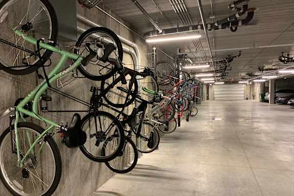 A bike rack with many bikes hanging on it.