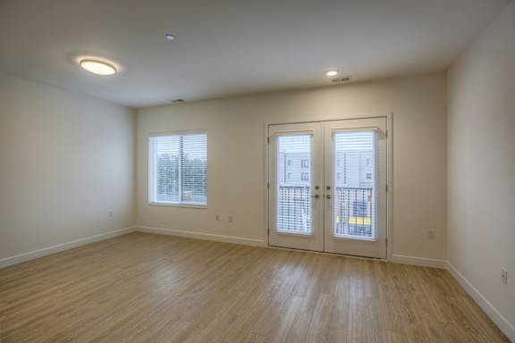 A room with wooden floors and white walls.