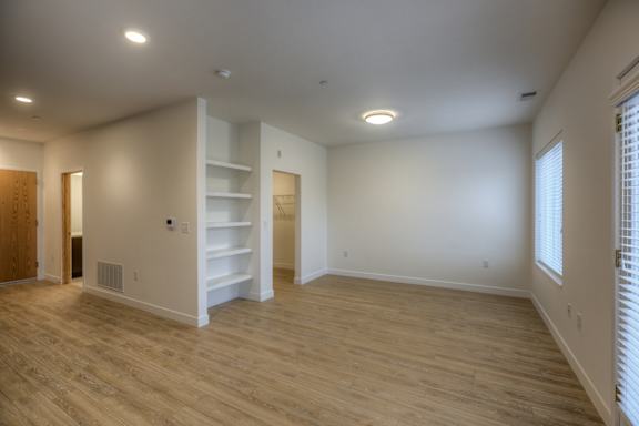 A room with wooden floors and white walls.