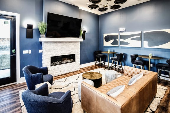 Resident Lounge with Fireplace, Bar, and Kitchen Area at The Fireside at Waukee in Waukee, IA