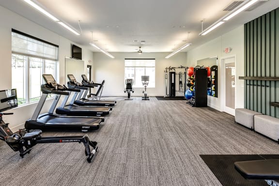 a spacious fitness center with treadmills and other exercise equipment at Hanover Flats in Bennington, NE