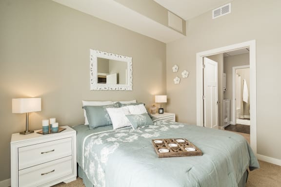 a bedroom with a bed and a mirror
