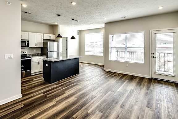 A kitchen with a black island in the middle of the room.