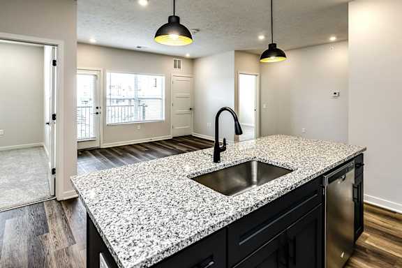 A kitchen with granite countertops and a sink.