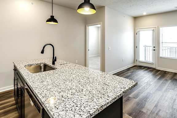 A kitchen with granite countertops and a sink.