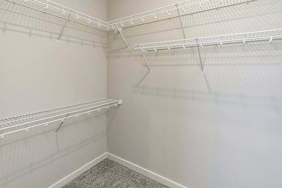 Empty white shelves in a room.